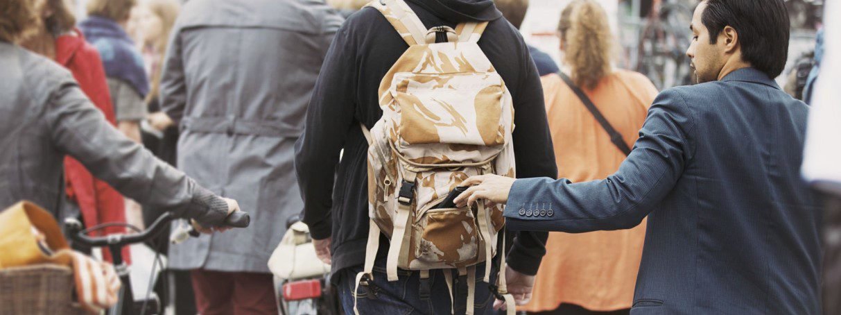 Image illustrating how to avoid pickpocketing with secure bags, awareness, and smart travel tips in crowded areas.