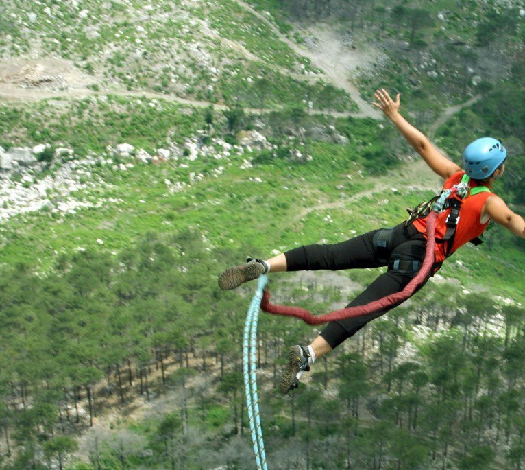 Bungee jumper leaping off a bridge with breathtaking views in Africa.