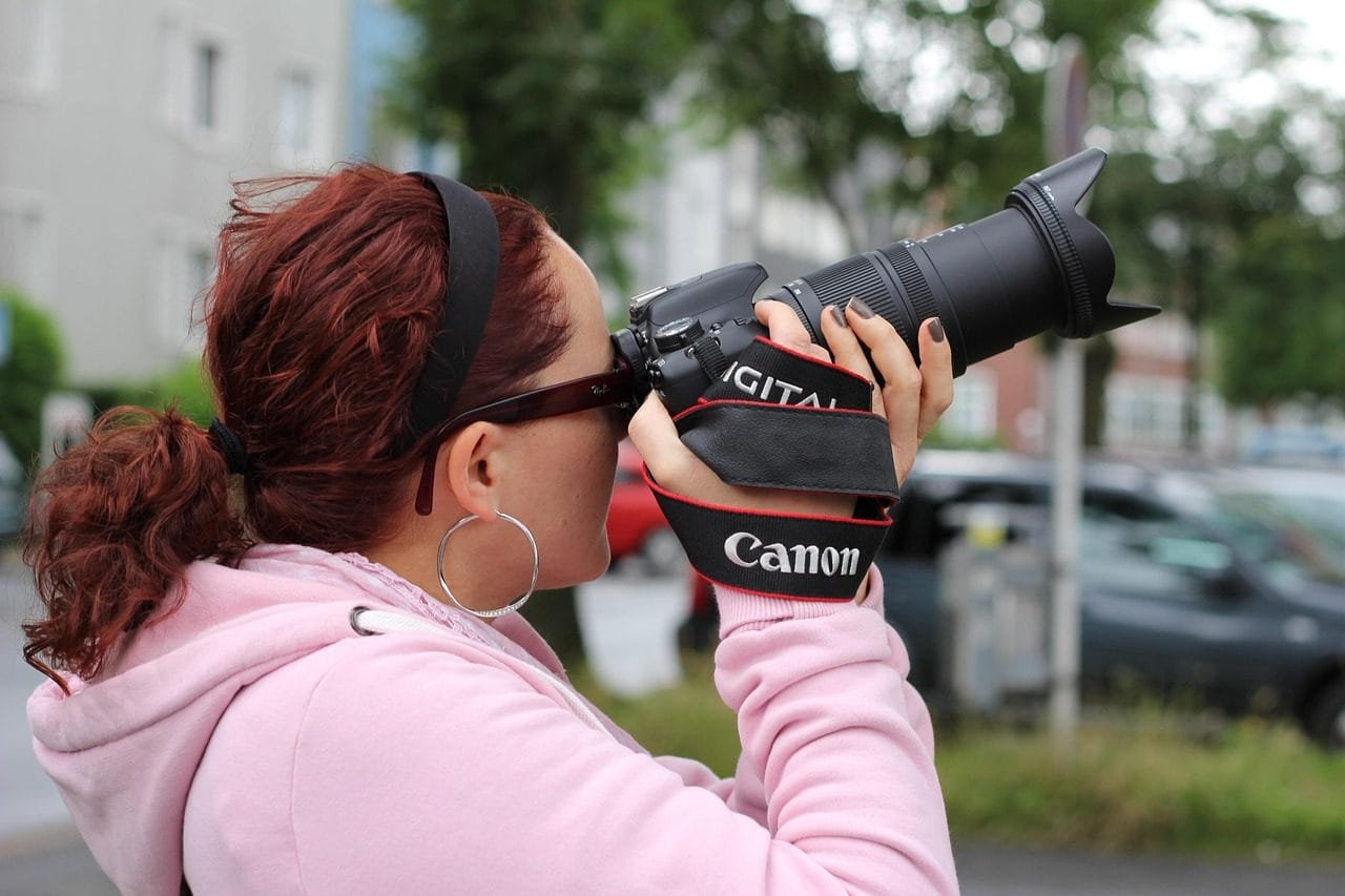 Photographer capturing a moment during a gorilla trekking adventure in the wild