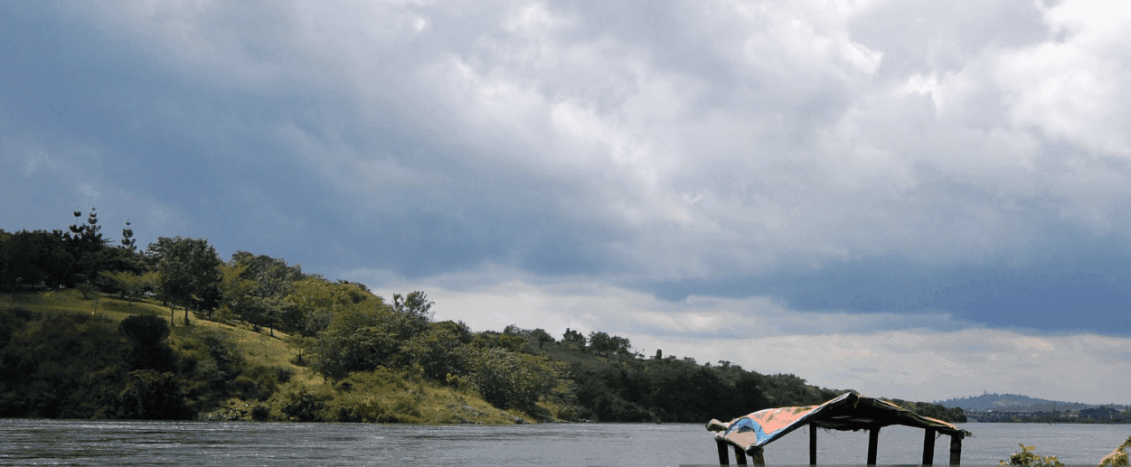 Rafting through Nile rapids at golden hour, sunlight glistening on water.