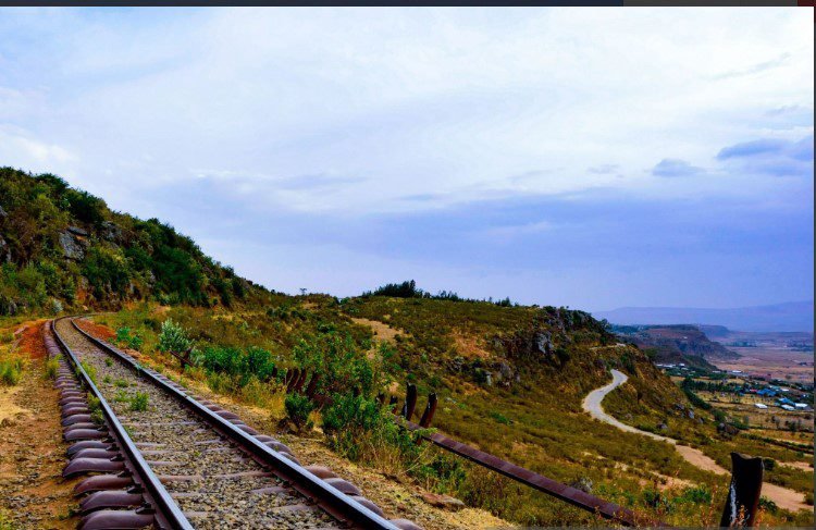 Train traveling through scenic landscapes in Kenya, showcasing beautiful views along the country's railway routes